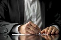 A Lawyer Signing a Will Document — Work Injury Attorney for Westmoreland, PA