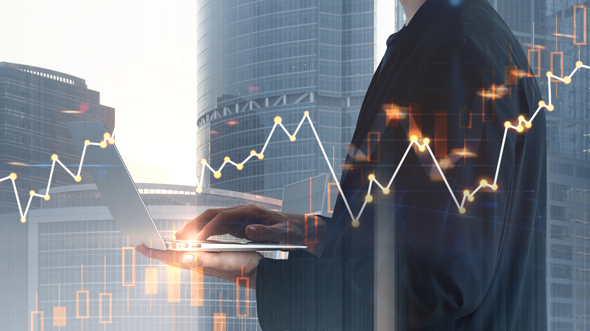 Man in a suit using laptop, overlaid with financial stock chart against a cityscape background.