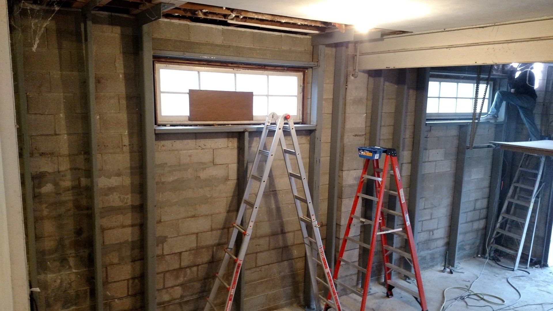 foundation crack repair near me A ladder is sitting in a room next to a window.