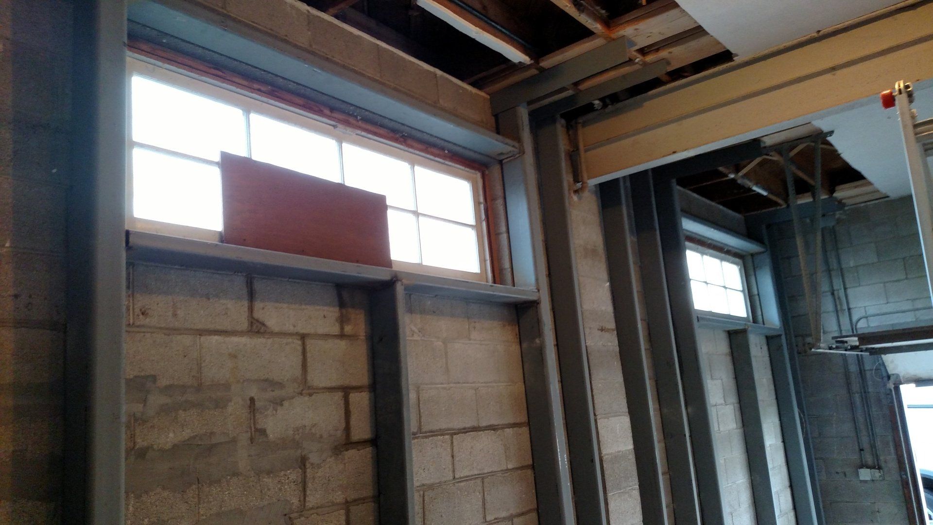 basement leak repair near me A building under construction with a lot of windows and brick walls.