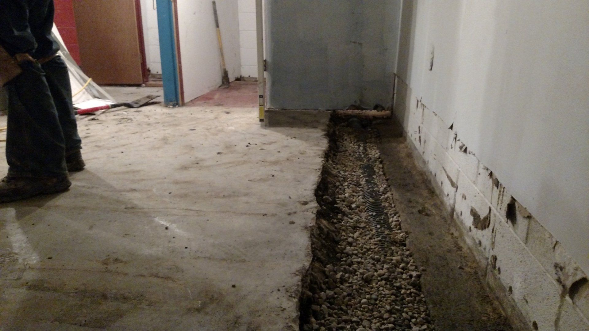 basement repairs A person is standing in a room with a hole in the floor.
