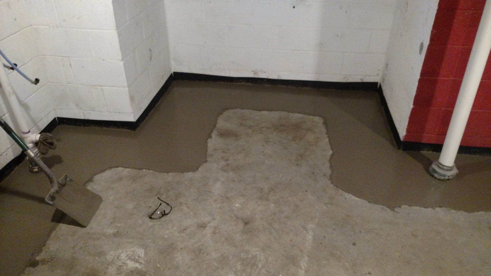 drain tiles A room with a lot of concrete on the floor.