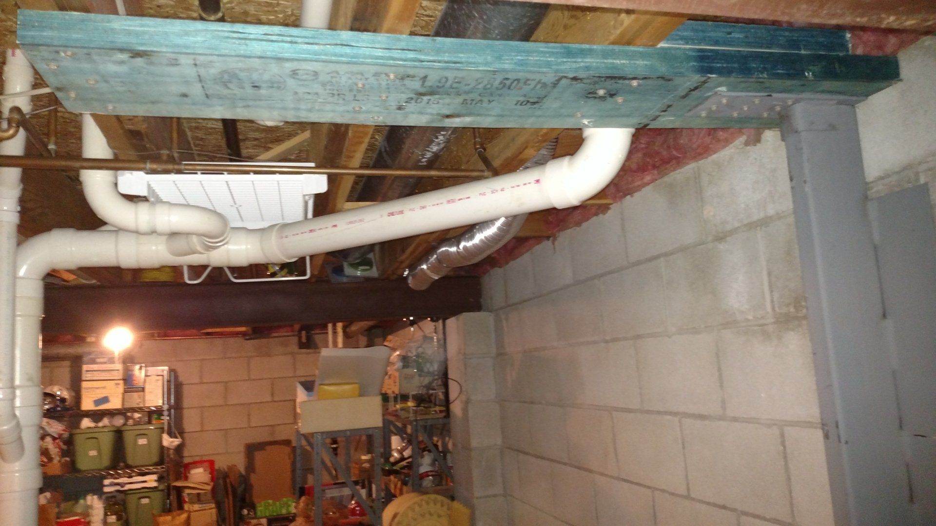 foundation restoration A basement with a lot of pipes coming out of the ceiling.