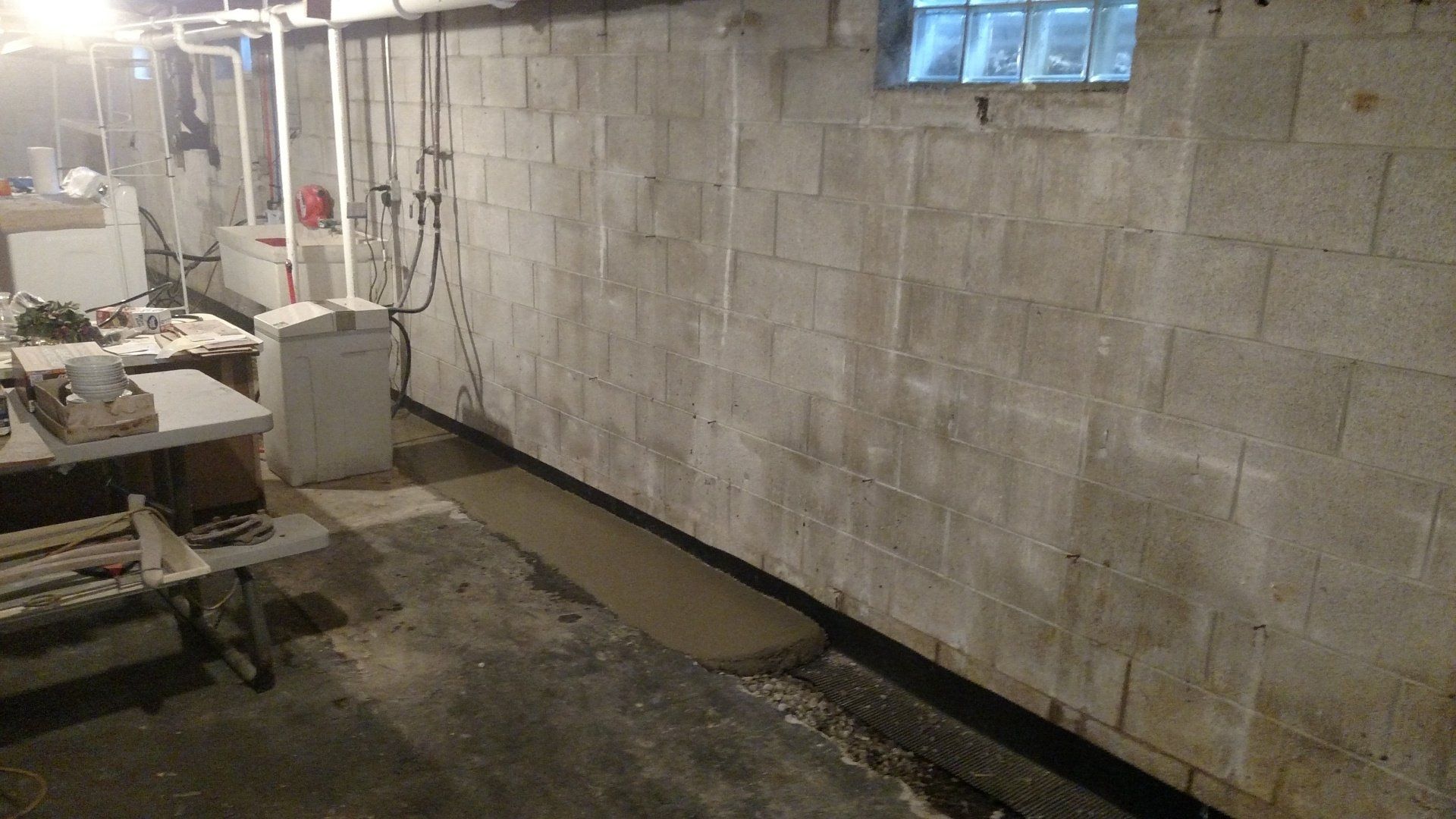 horizontal foundation cracks A basement with a brick wall and a window.