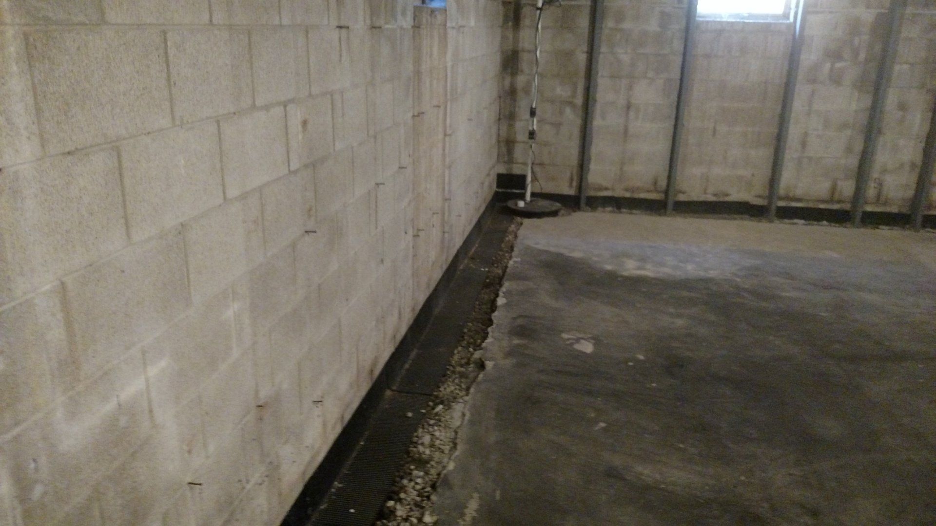foundation block A basement with a concrete floor and a brick wall.