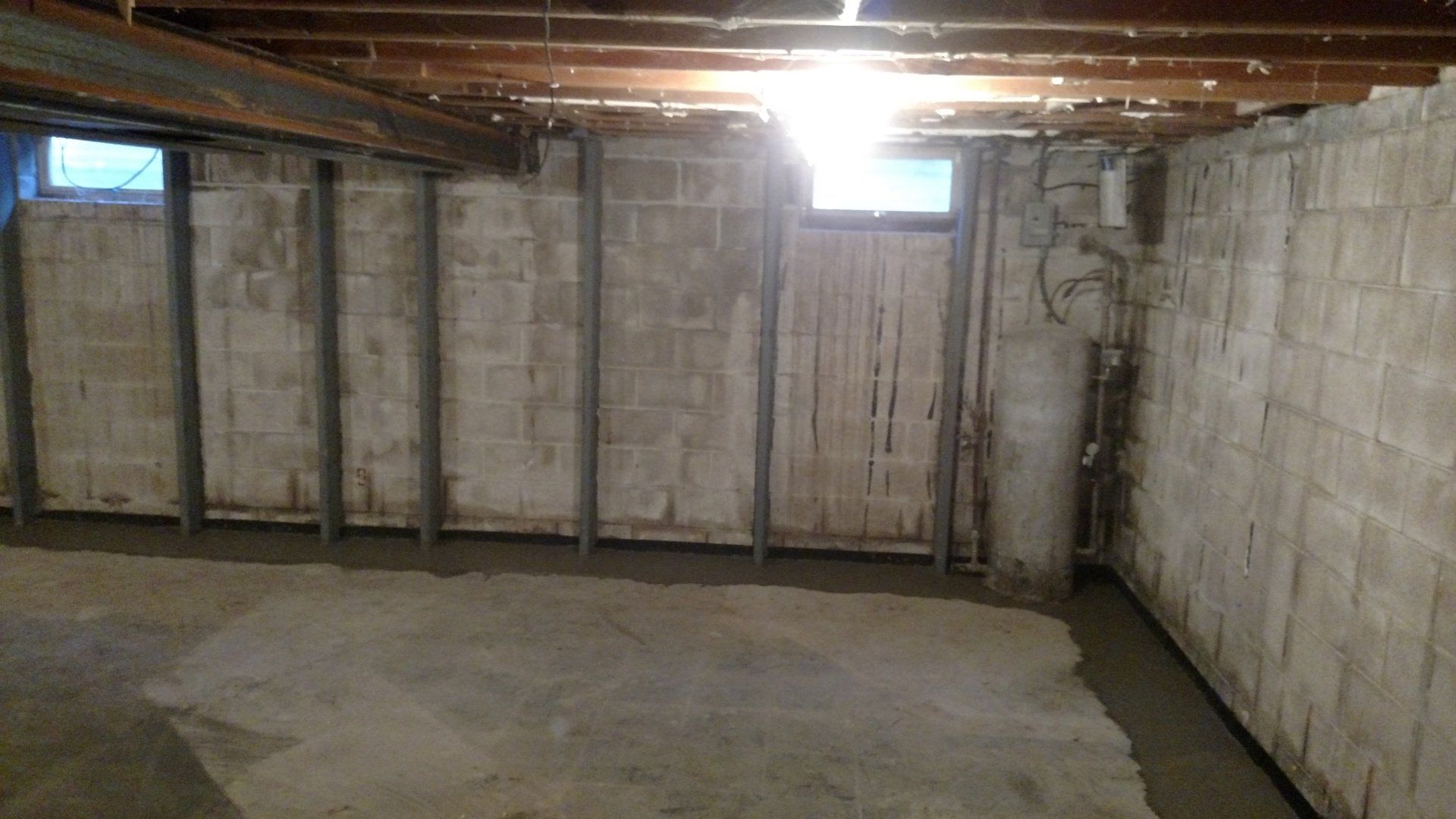 glass block basement windows A basement with brick walls and a concrete floor.