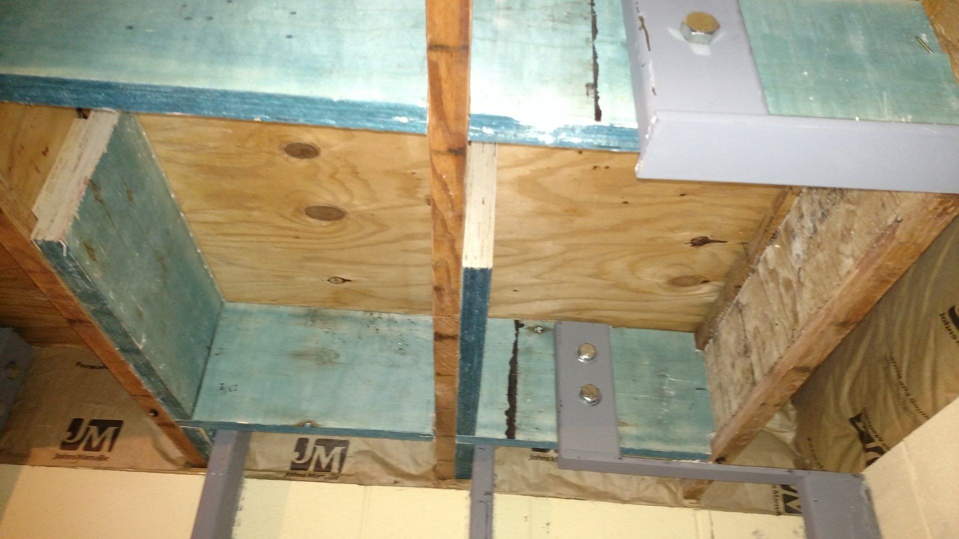 basement repair near me A close up of a wooden ceiling with a metal frame.