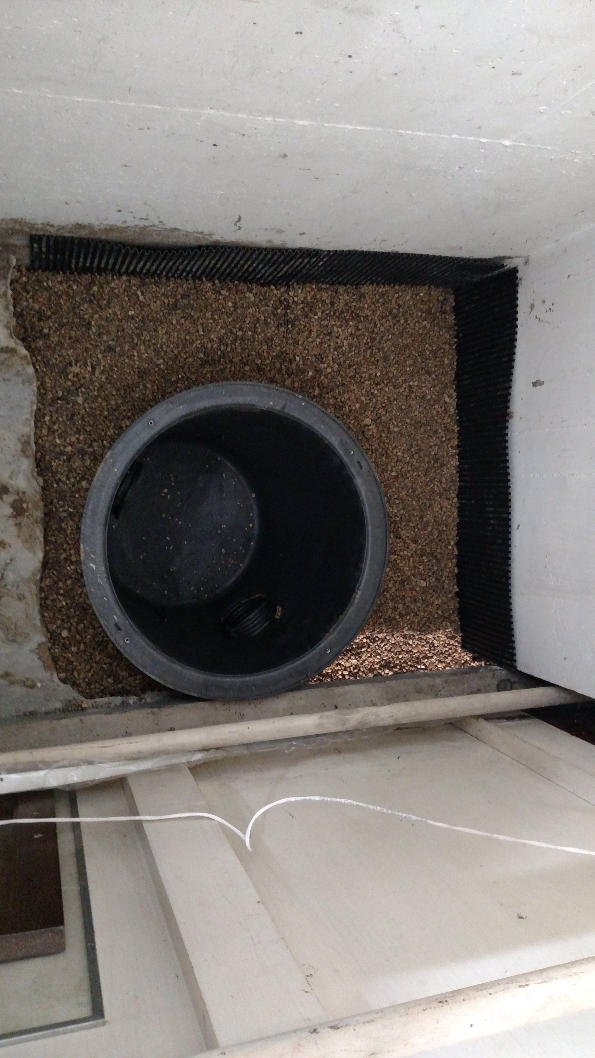 foundation specialist There is a hole in the wall with a pipe coming out of it.