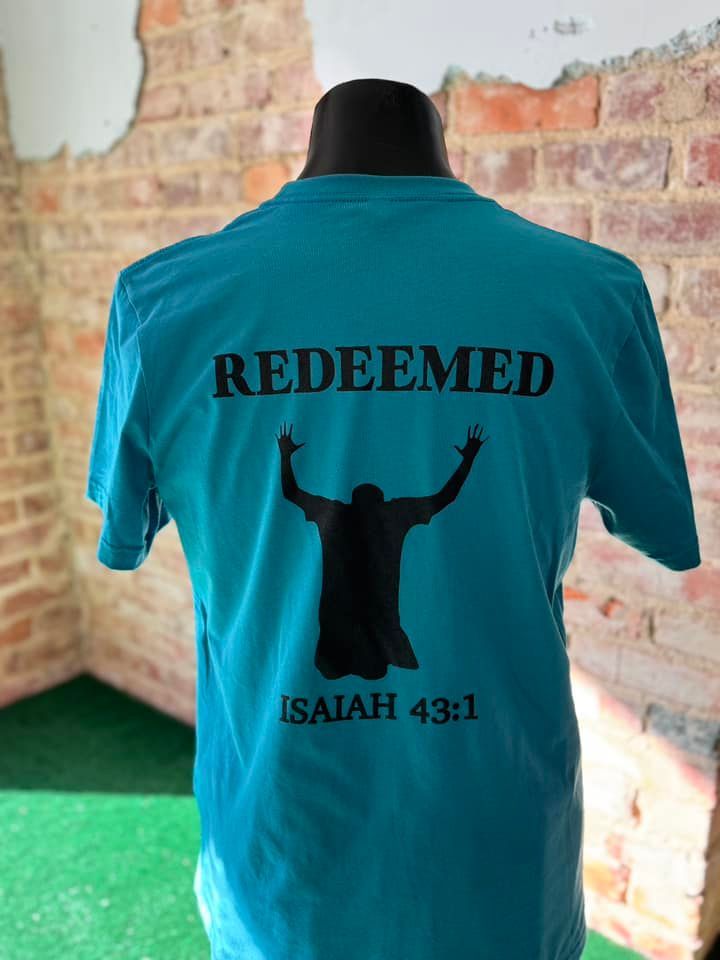 A blue t-shirt that says redeemed is on a mannequin