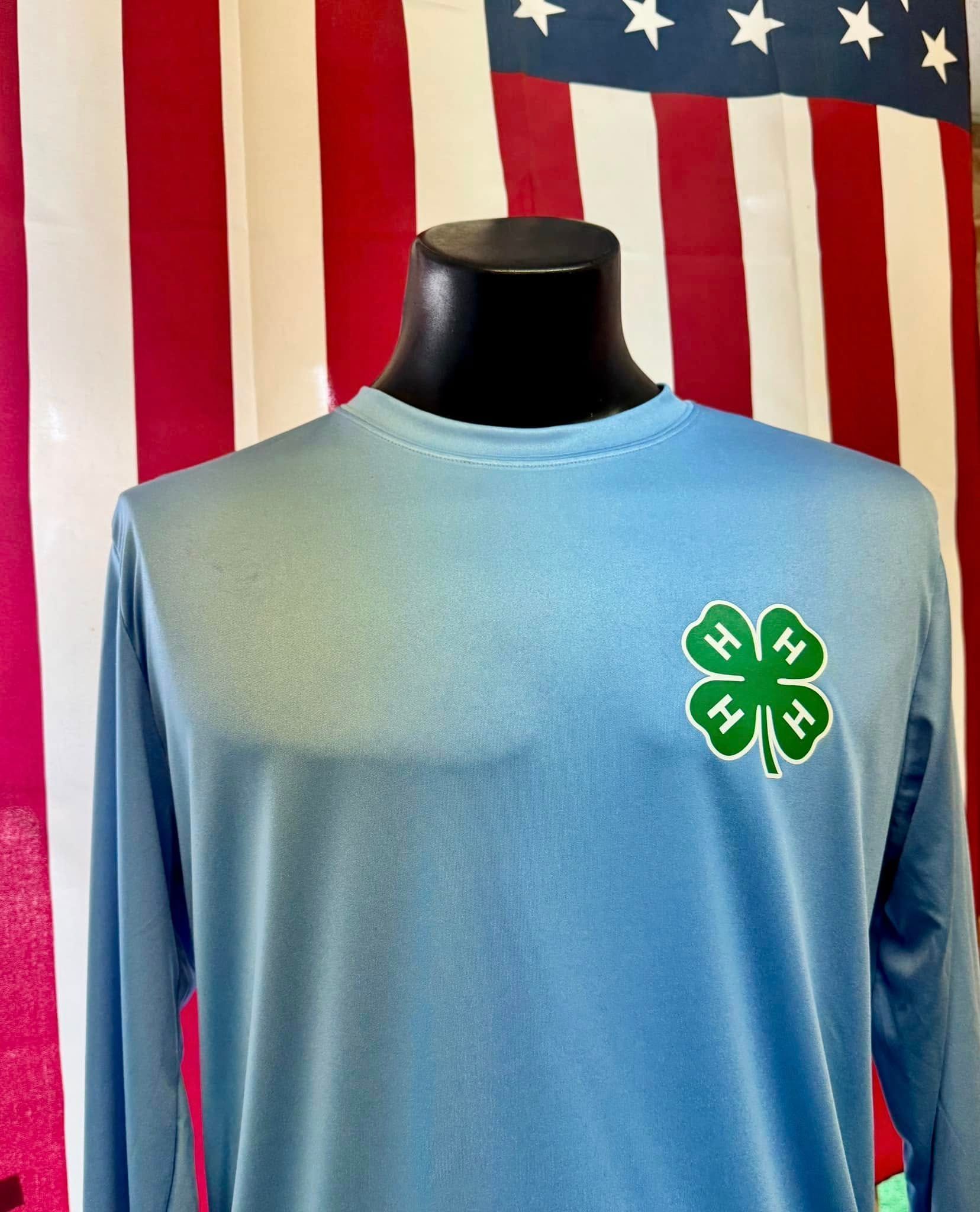 A blue shirt with a green four leaf clover on the front