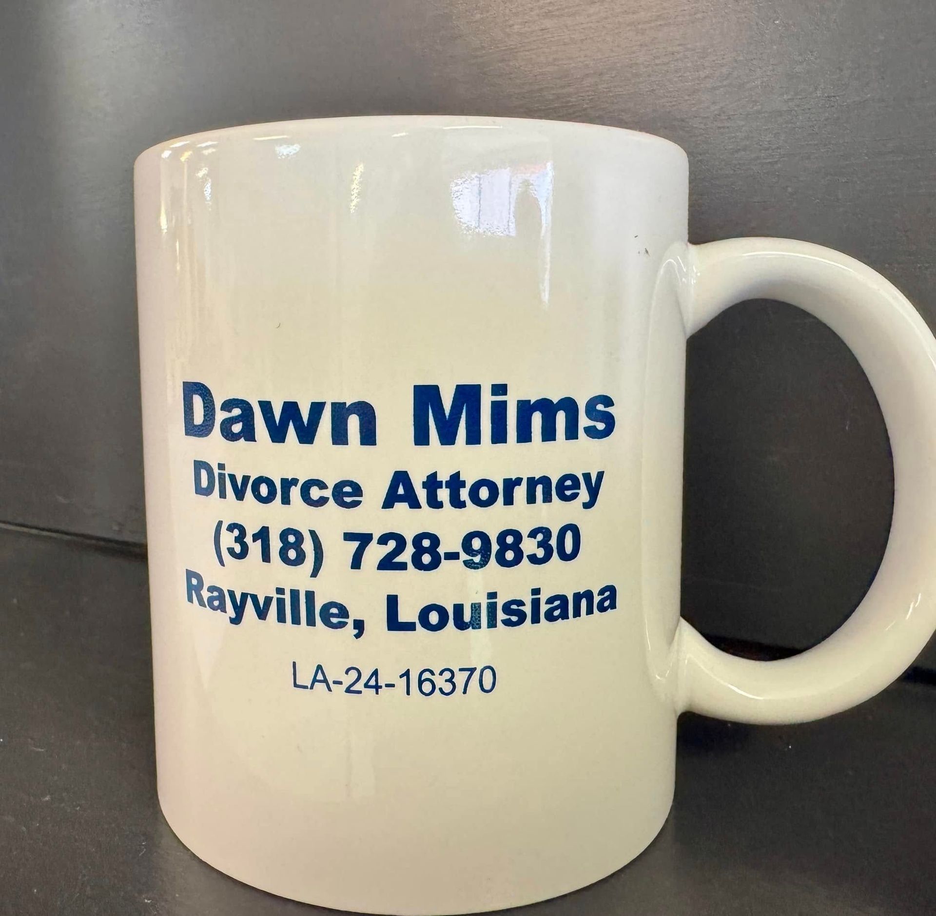 A white coffee mug that says dawn mims divorce attorney