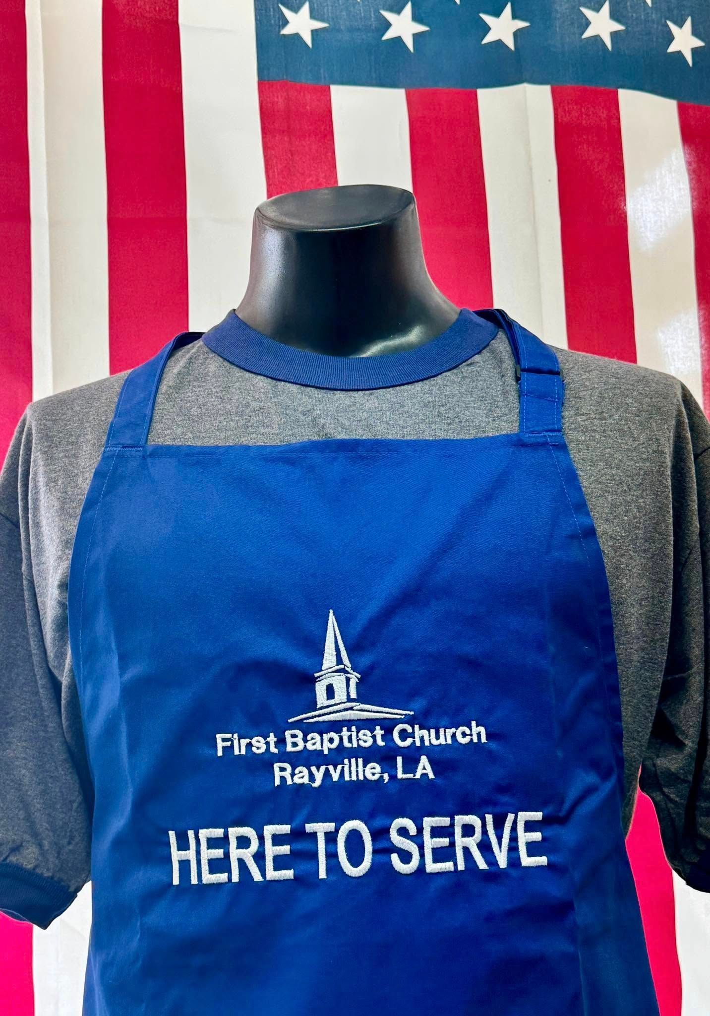 A blue apron with the words here to serve on it