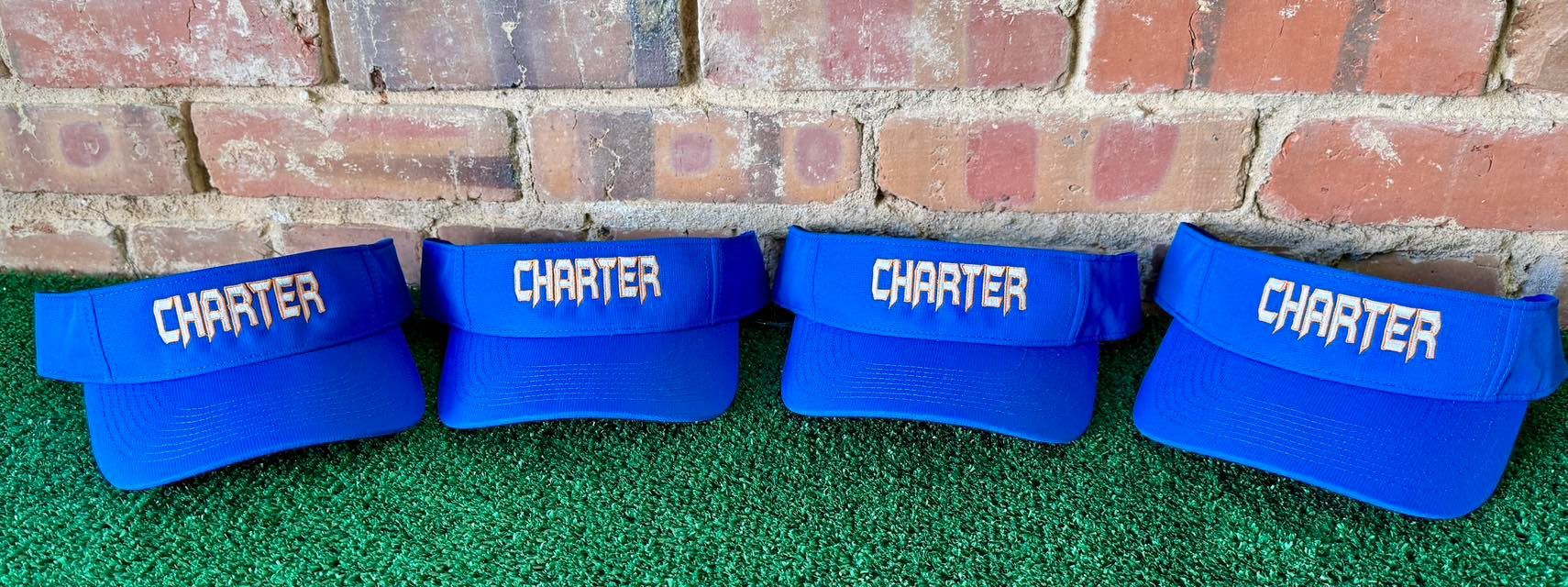 Four blue visors with the word charter on them