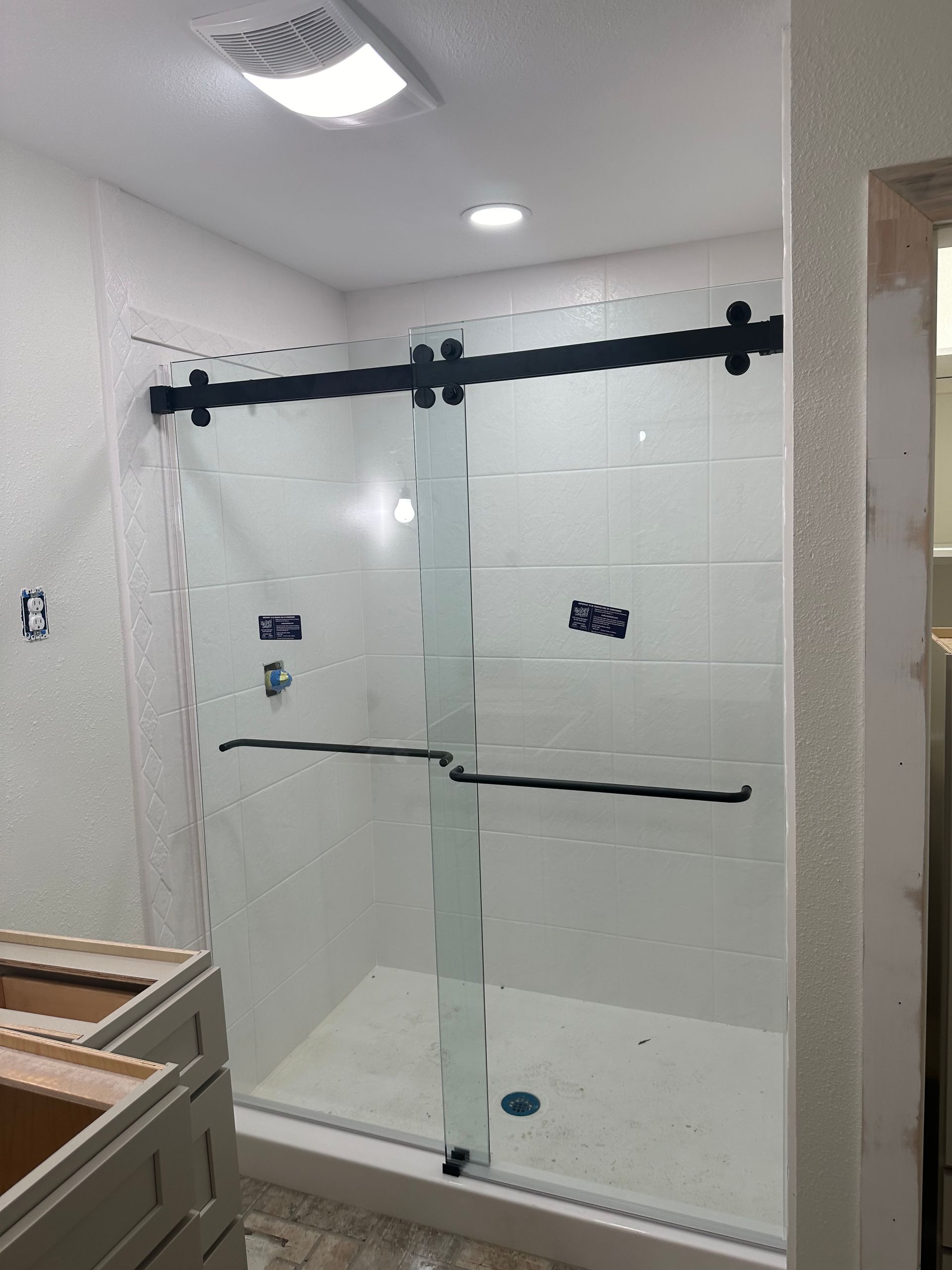 A Bathroom with A Sliding Glass Shower Door - New Orleans, LA - The Clear Choice