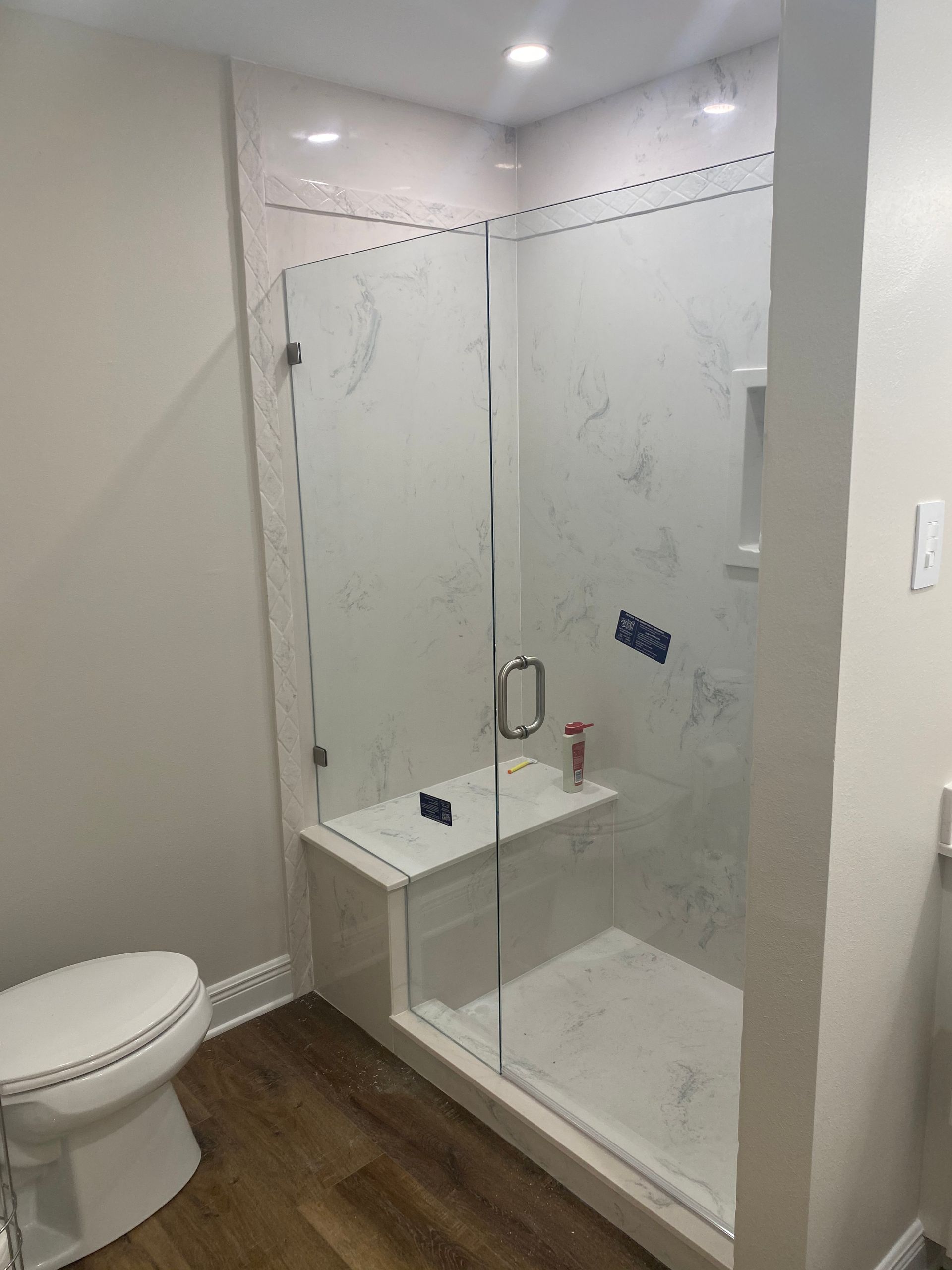 A Bathroom with A Toilet and A Walk-in Shower with A Glass Door - New Orleans, LA - The Clear Choice