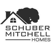 Logo for Schuber Mitchell Homes, featuring a house silhouette and a tree. 