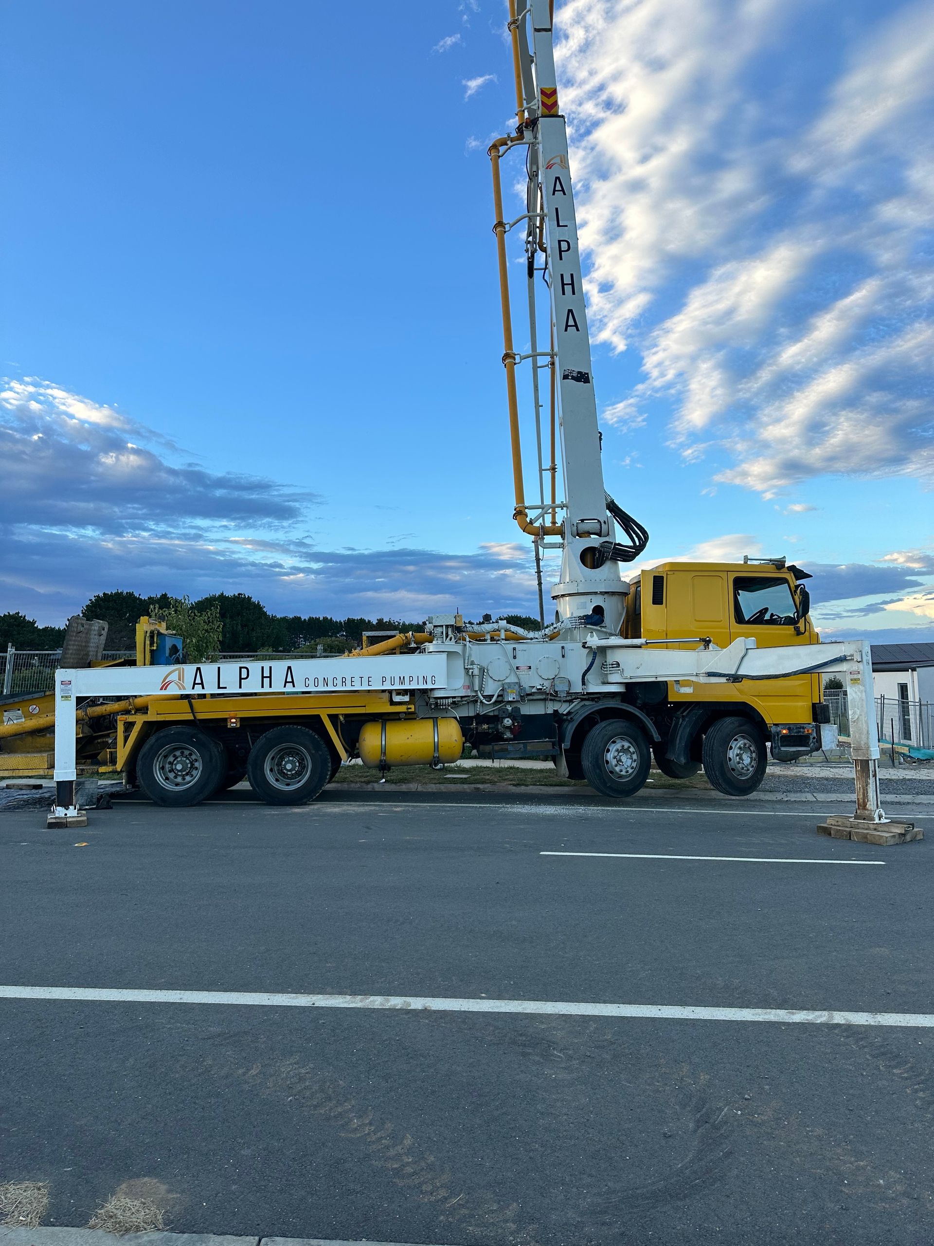 An aerial view of a concrete pump truck at a construction site.