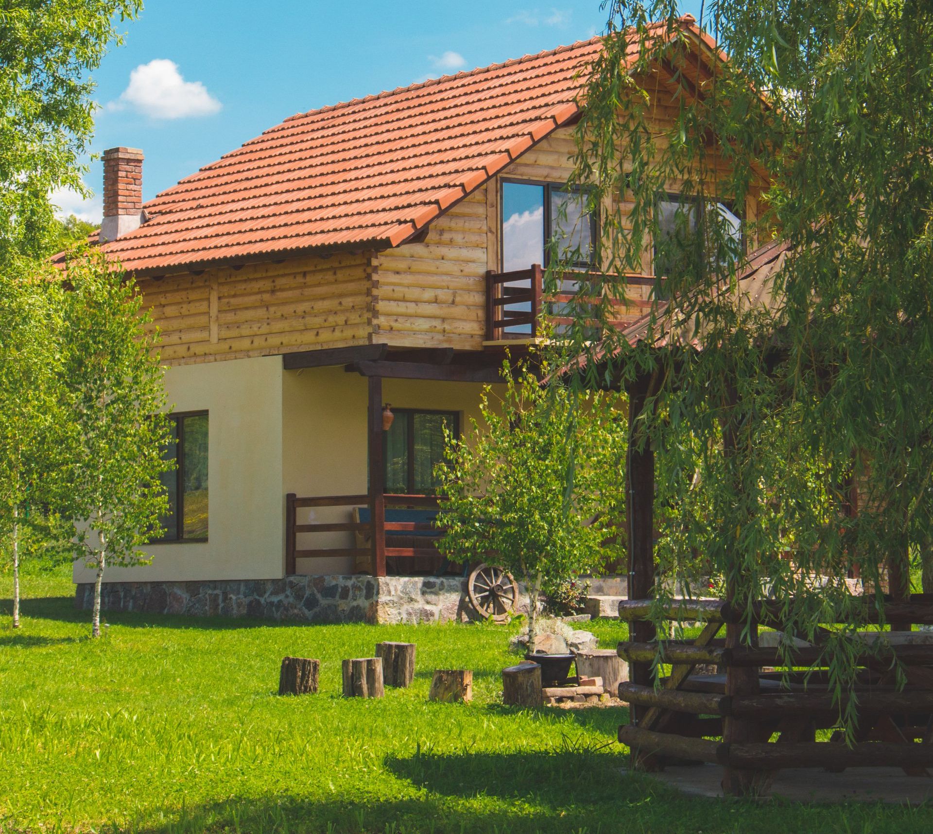 cabin log home with green grass and trees