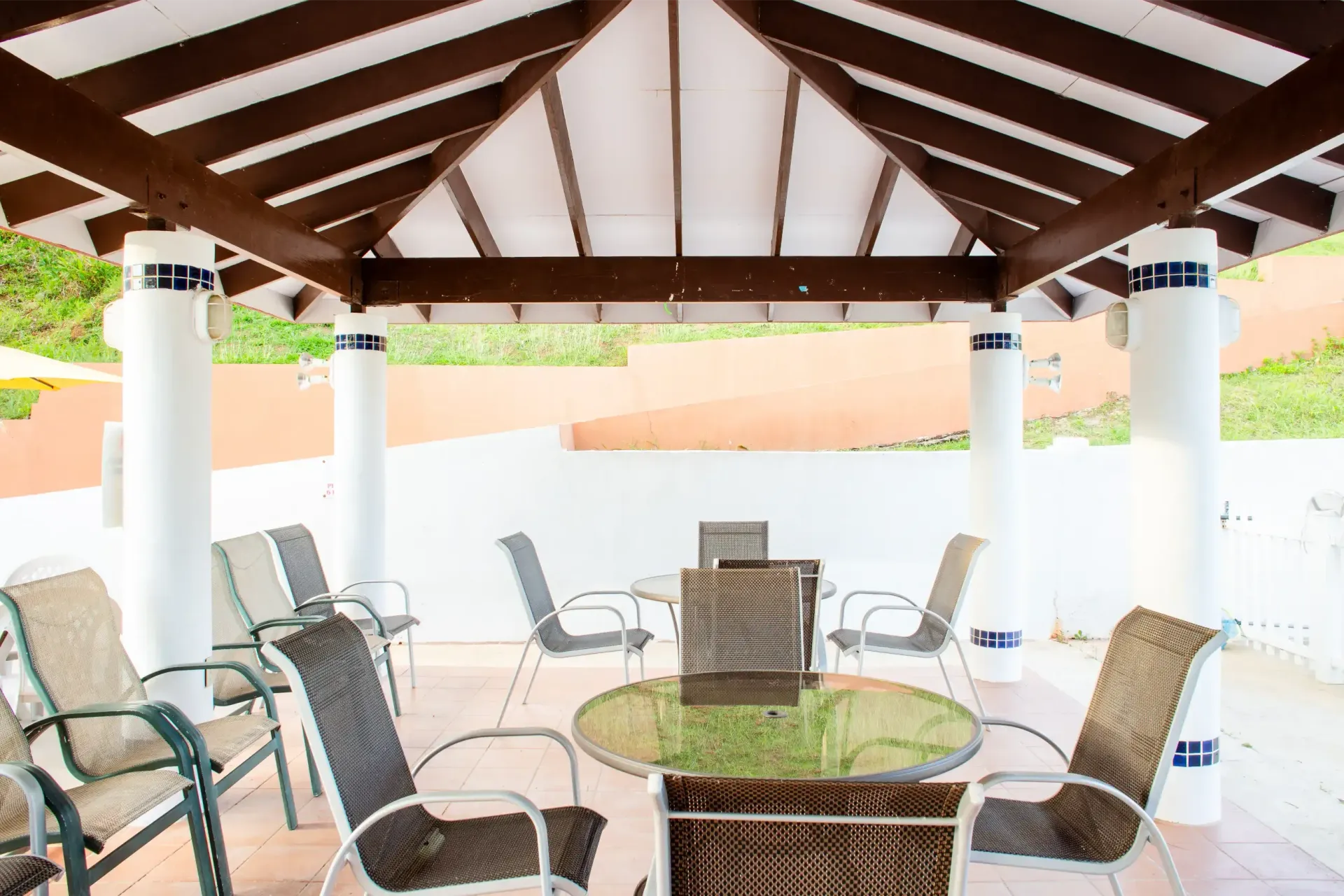 There is a table and chairs under a gazebo.