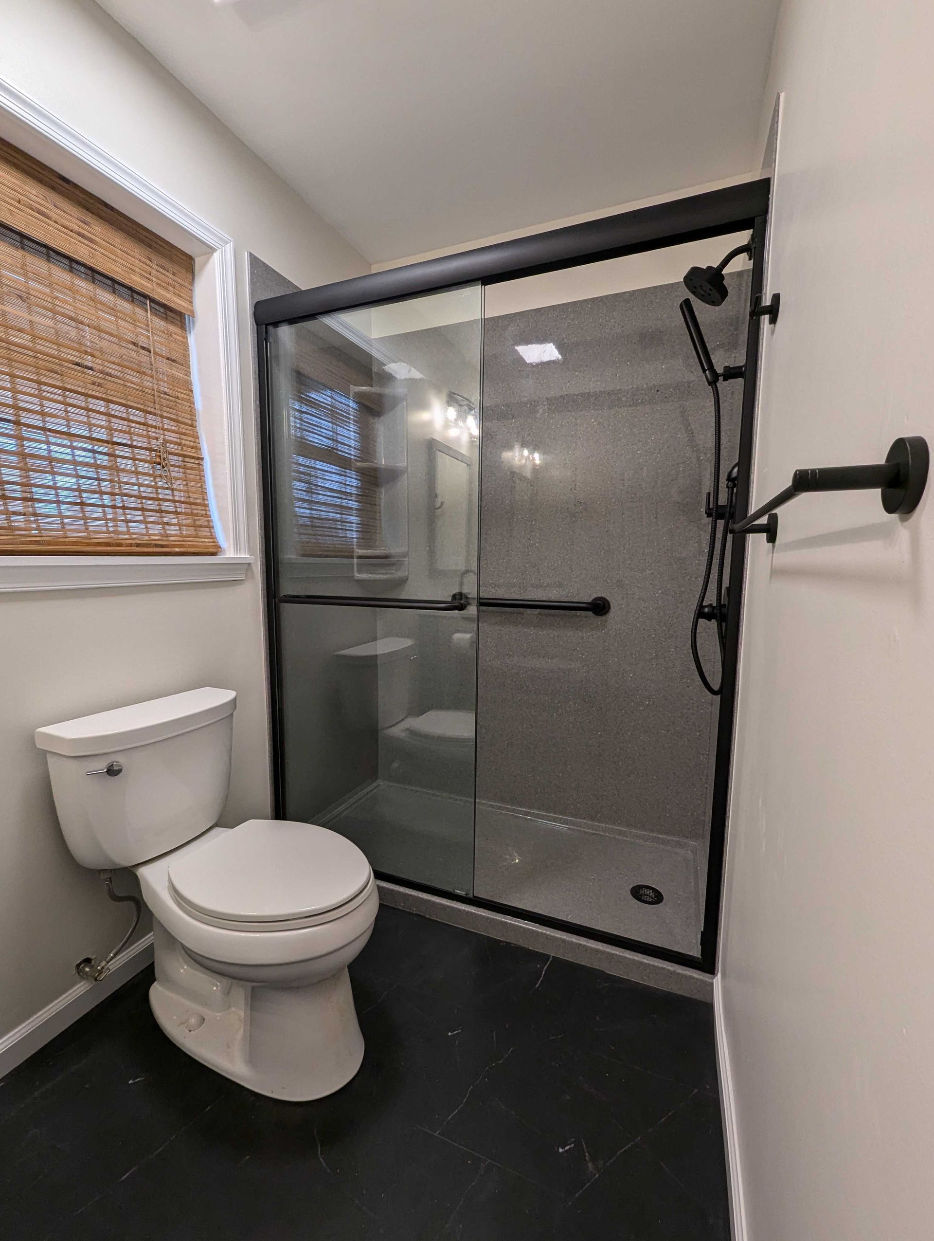 black shower installation with new flooring bathroom remodel