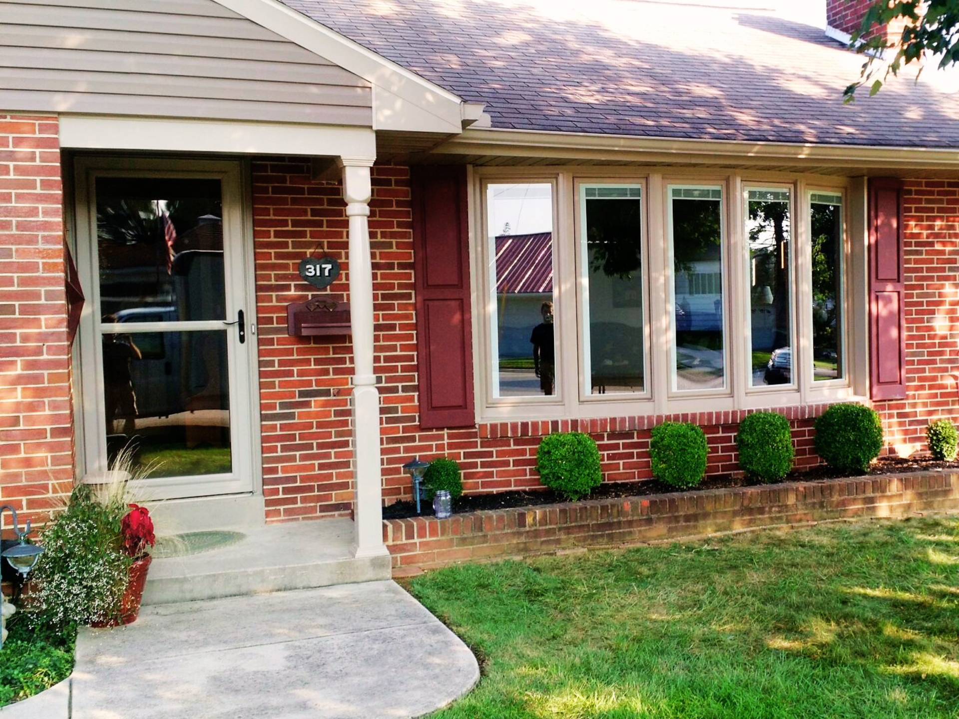 front door with glass screen and five panel bay window installation