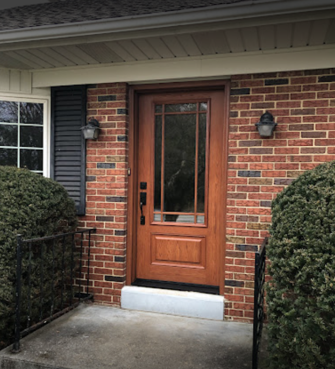 wooden front door with glass panel