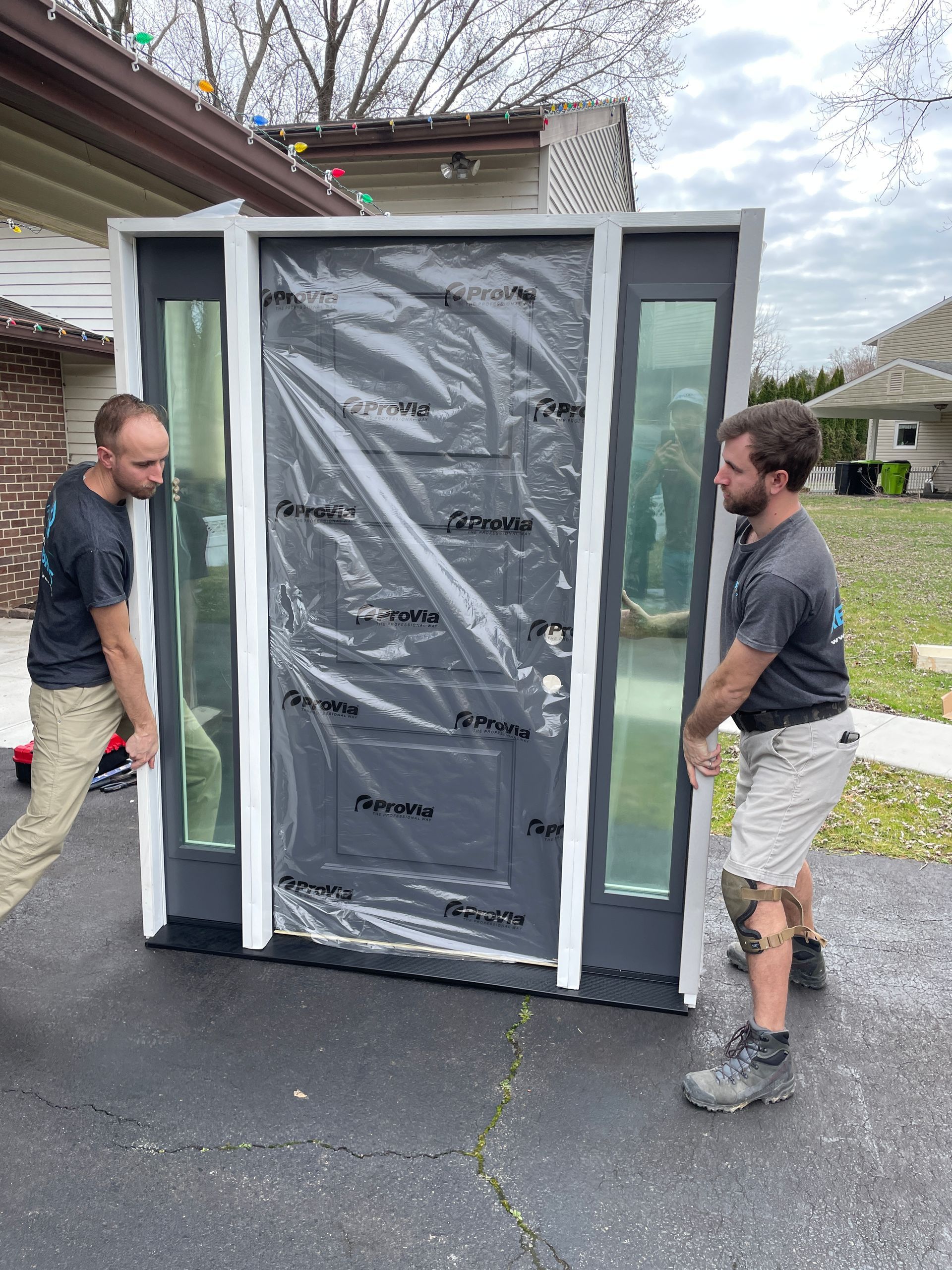 the reno bros installing a front door with two side window panels