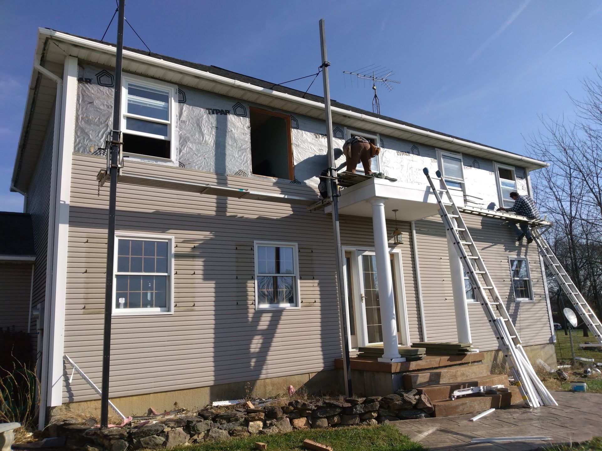 the reno bros installing siding and windows outside of Lancaster pa house