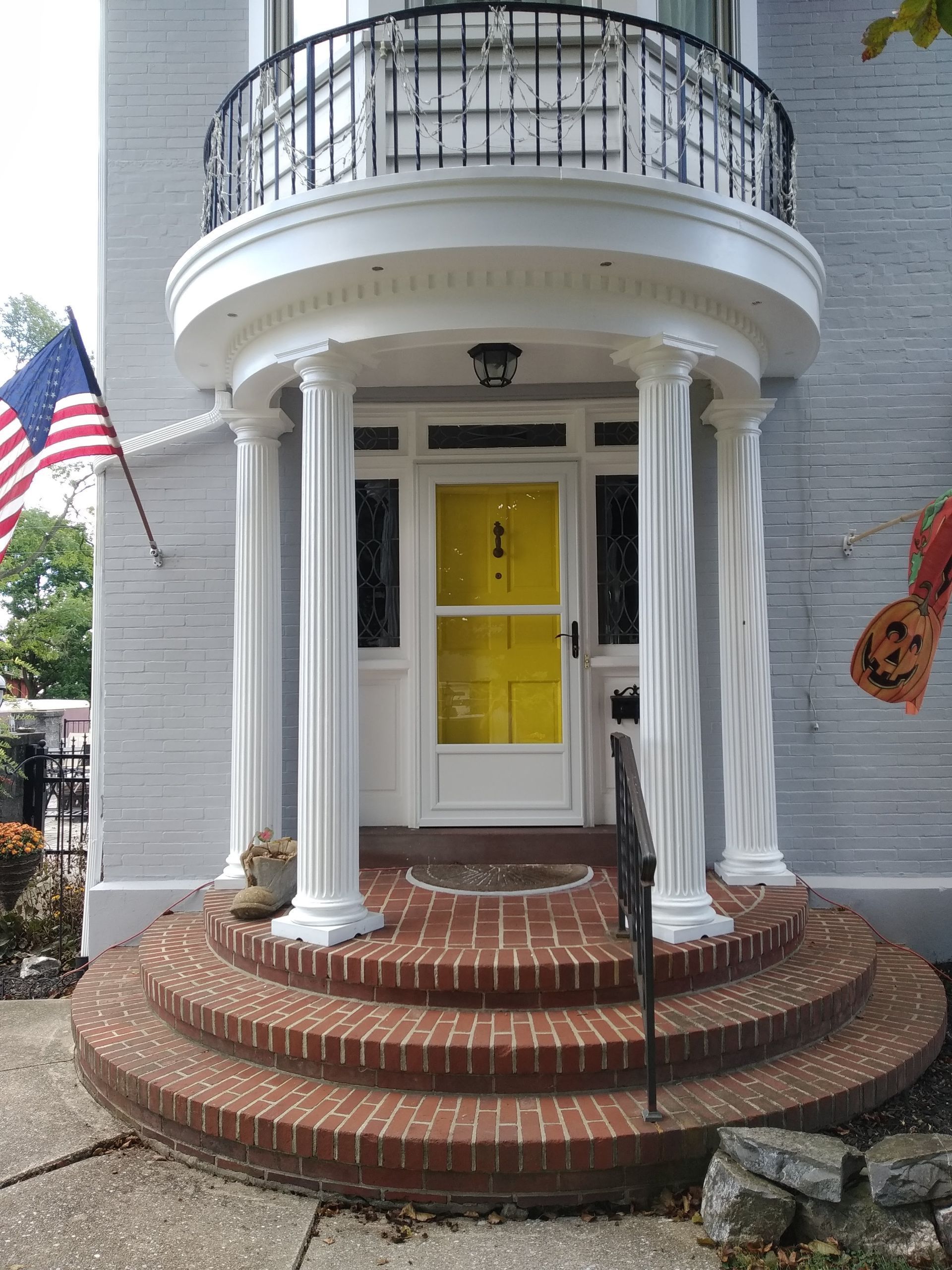 yellow front door with glass screen and architraves trim