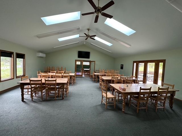A large room with tables and chairs in it