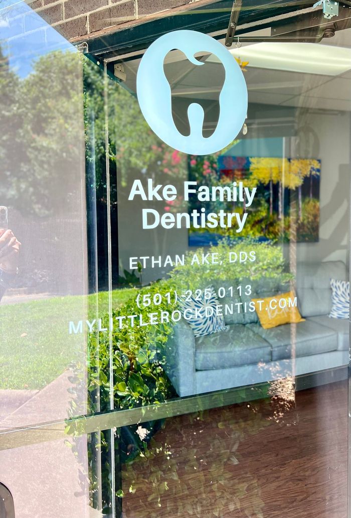 a reflection of a dentist 's office in a glass door .
