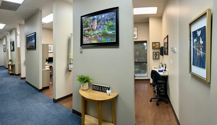 a dental office with a table and a television on the wall .