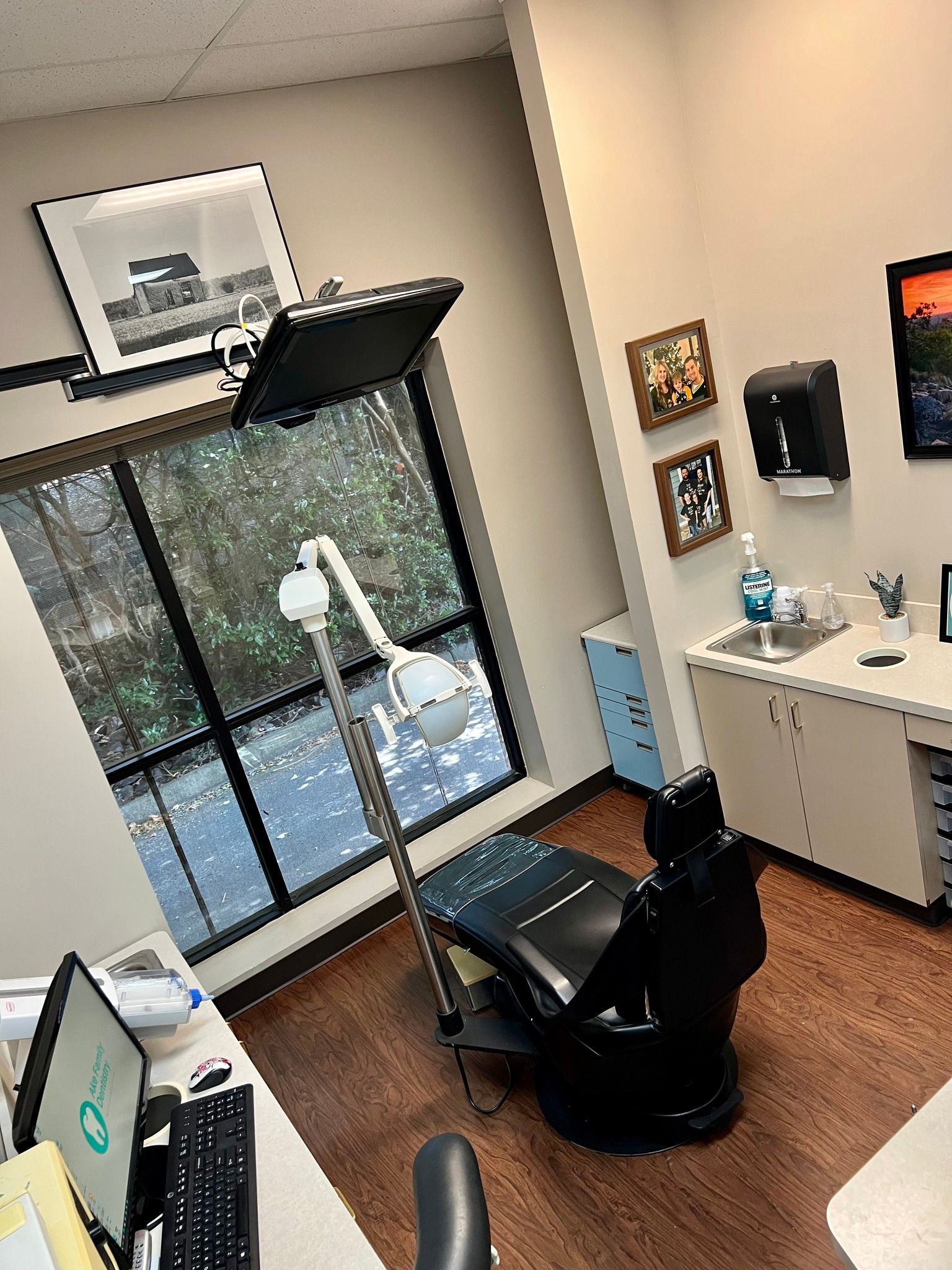 a dental office with a dental chair and a sink .