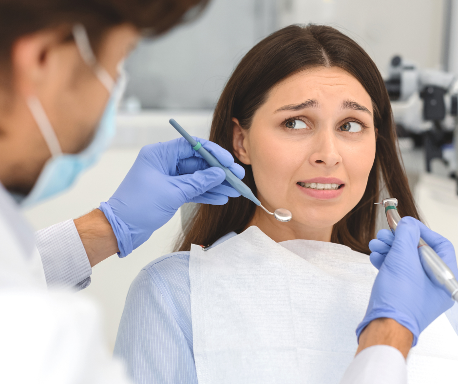 a woman is having her teeth examined by a dentist .