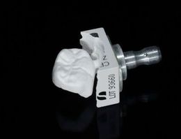 a close up of a piece of dental equipment on a black surface .