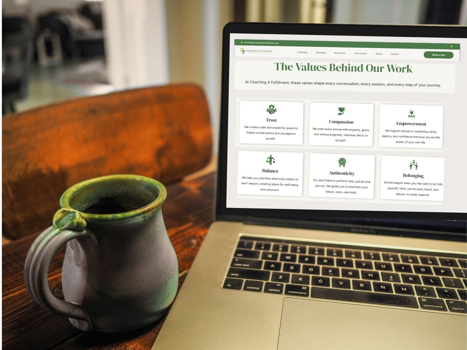 A woman is sitting on a couch talking to another woman.