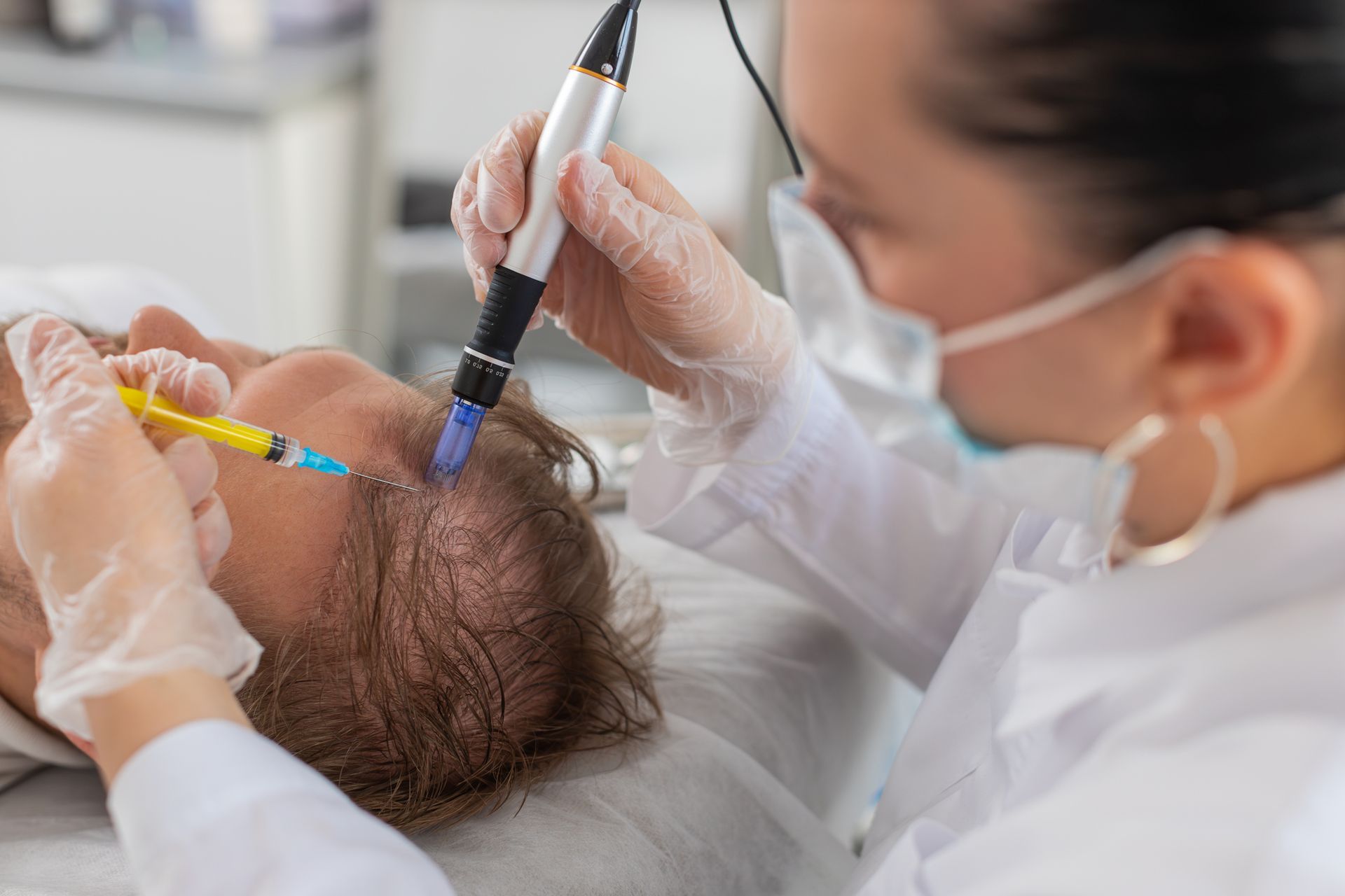 A woman is giving a man a botox injection in his head.