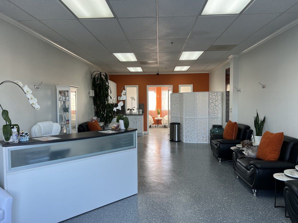 A large room with a couch and a desk in it