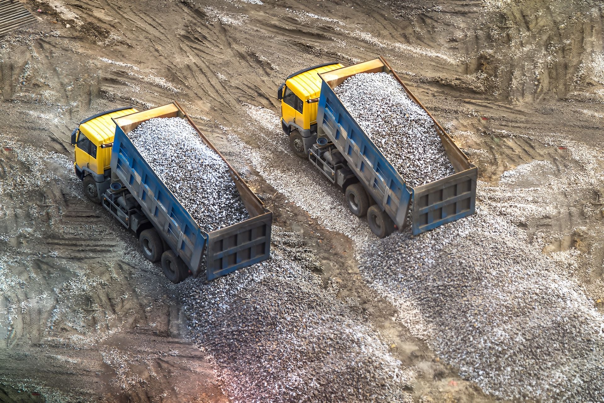 Two Dump Trucks Dumping Gravel on a Construction — Compass Equipment Hire in Yamba, NSW