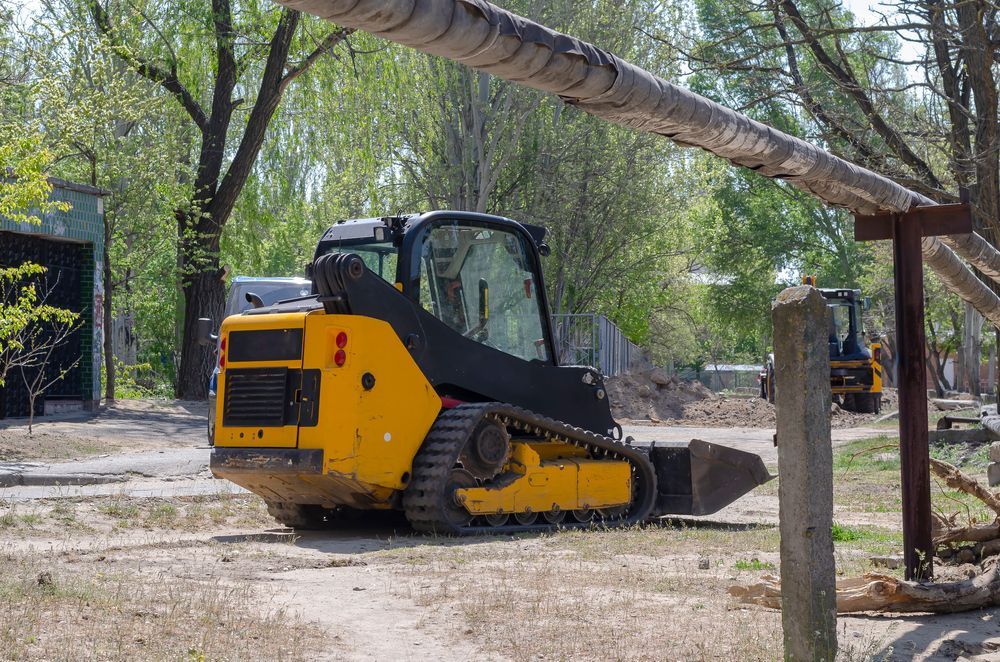 Yellow Skid Steer on Tracks Parked — Compass Equipment Hire in Tweed Heads, NSW