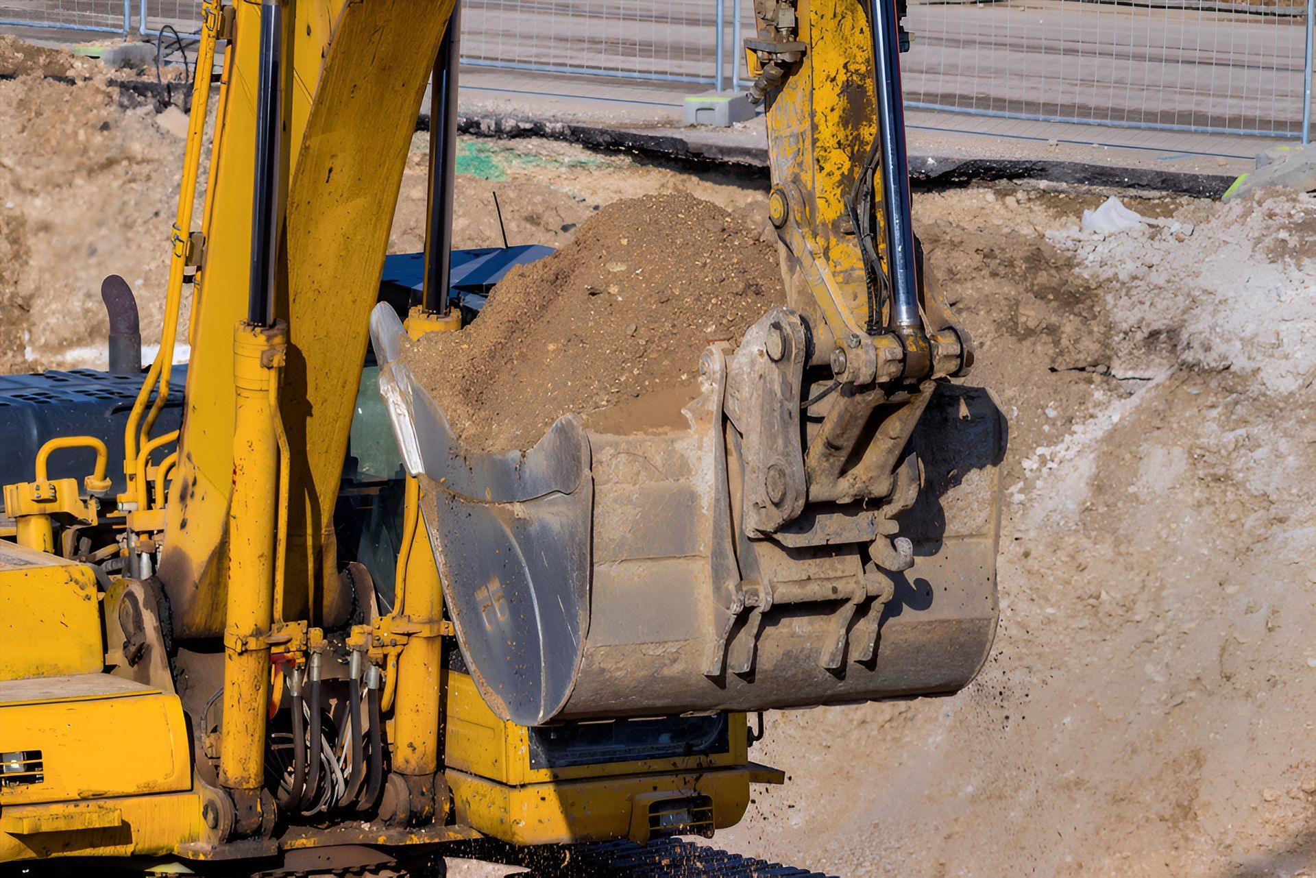 Yellow Excavator Bucket Filled With Dirt — Compass Equipment Hire in Maclean, NSW