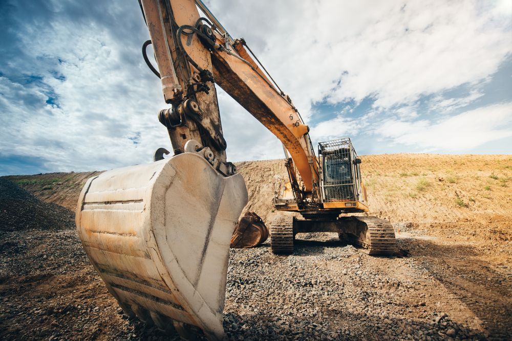 Excavator With Raised Bucket, Working at a Construction — Compass Equipment Hire in Yamba, NSW