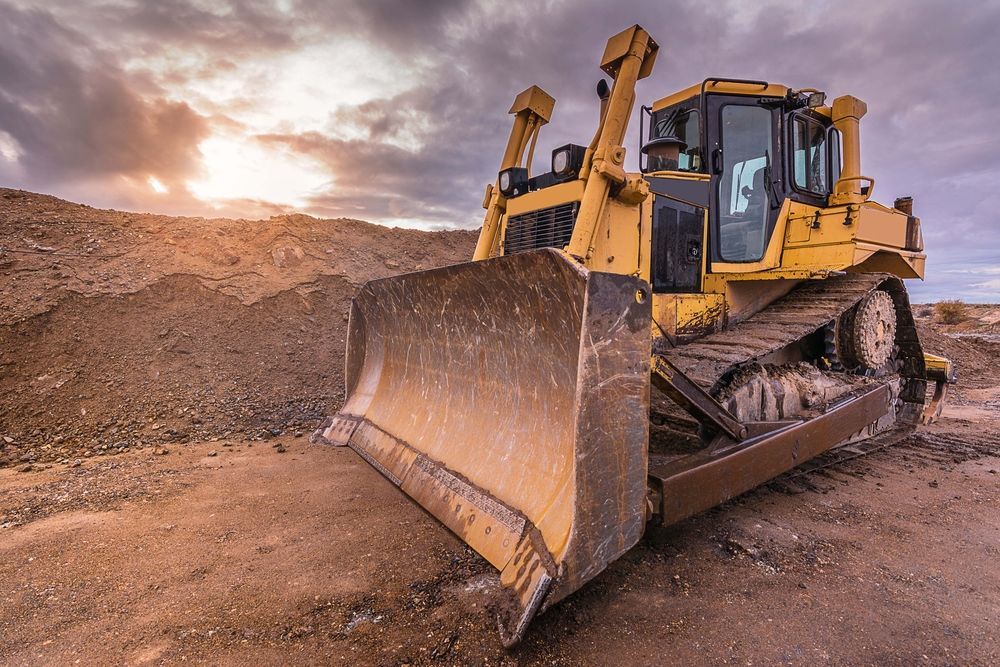 Yellow Bulldozer on a Dirt Road — Compass Equipment Hire in Coffs Harbour, NSW