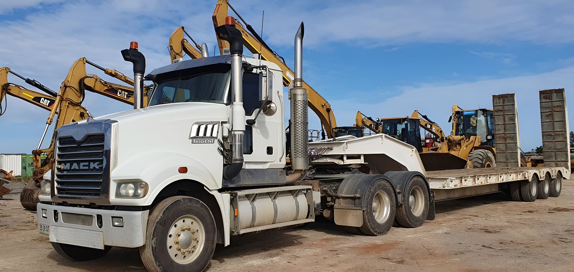 White Mack Truck Pulling a Flatbed Trailer — Compass Equipment Hire in Yamba, NSW