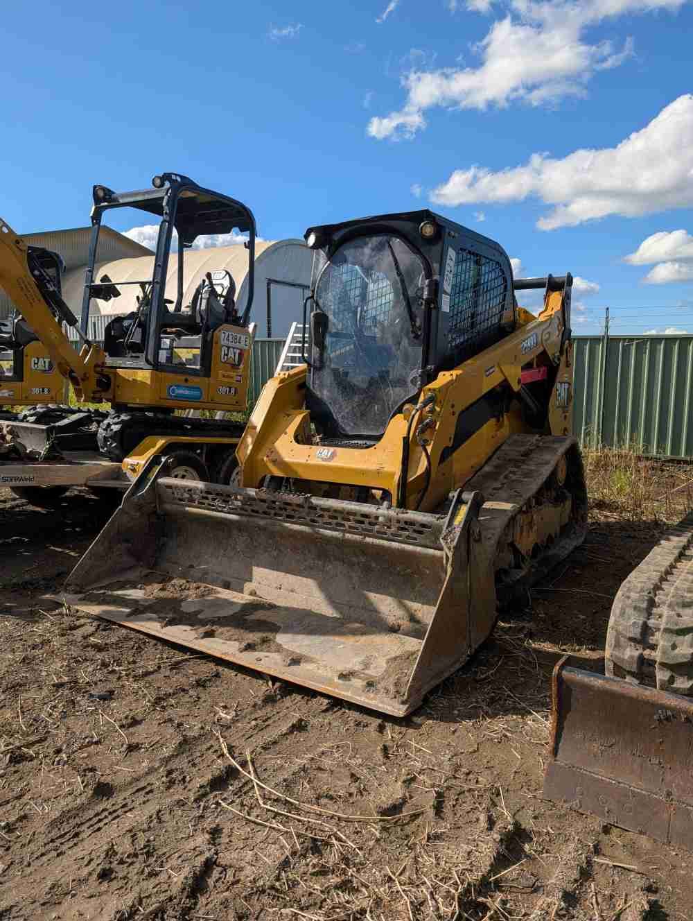 Yellow Skid Steer on Tracks Parked — Compass Equipment Hire in Tweed Heads, NSW