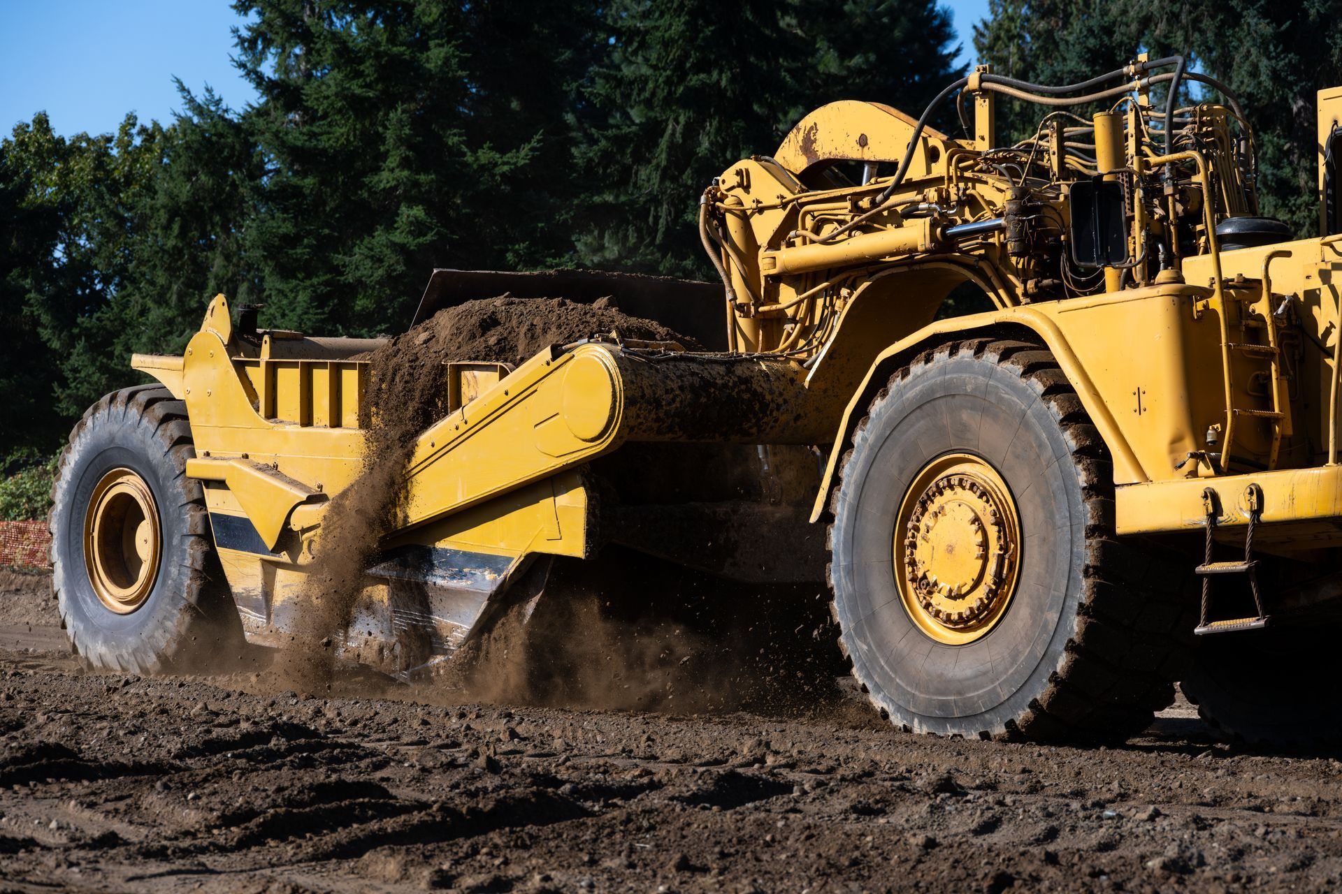 Yellow Scraper Machine Grading Dirt — Compass Equipment Hire in Woodburn, NSW