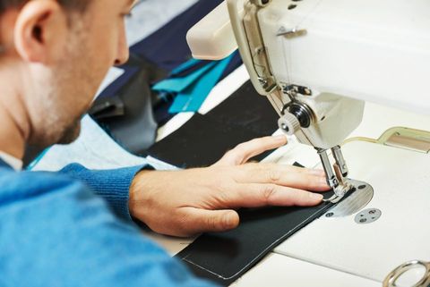 tailor stitching a fabric