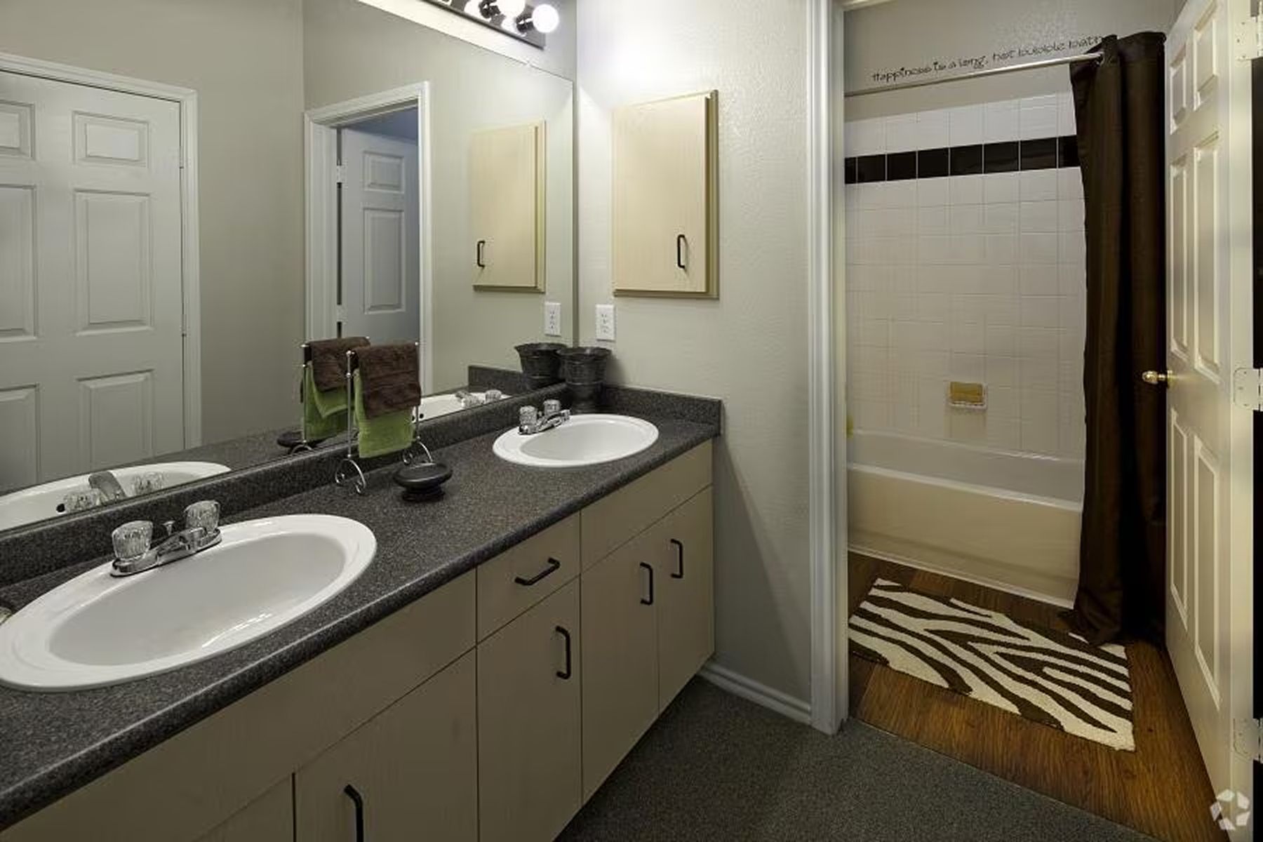 Spacious bathroom at Milestone Stillwater with double-sink vanity and full tub and shower.