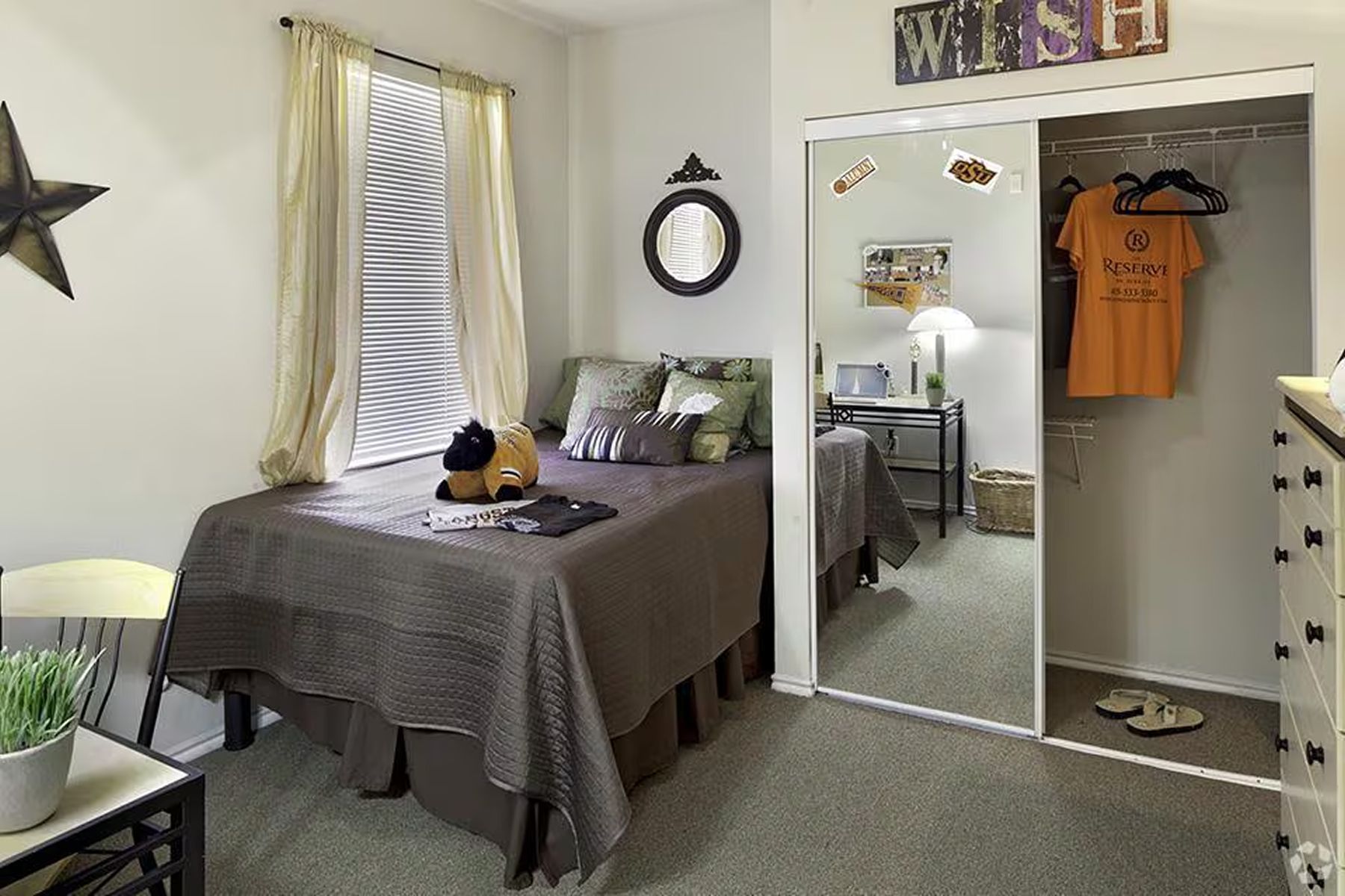 Bright student bedroom at Milestone Stillwater with full bed, dresser, and large closet.