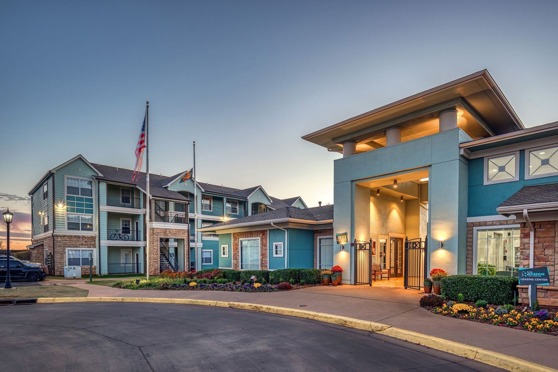Front entrance of Milestone Stillwater student apartments with modern architecture and evening lighting.